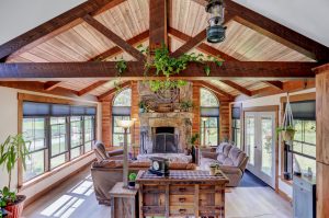 Living Room with Custom Wood Ceiling Beams Stone Fireplace and Wood Ceiling Planks