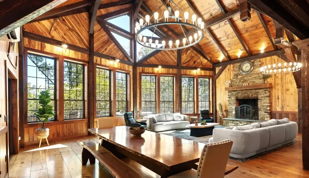 cabin living wooden beam wooden paneling and wide plank hardwood floors